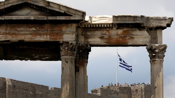 The Greek flag is framed by the arch of Hadrian atop the Acropolis hill in Athens, Greece June 26, 2015. The leaders of Germany and France offered to release billions in frozen aid on Friday in a last-minute push to talk Greek Prime Minister Alexis Tsipras into contentious pension reforms in exchange for filling Athens' empty coffers until November. REUTERS/Yannis Behrakis