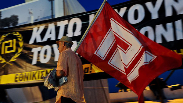 A protester with a Golden Dawn flag