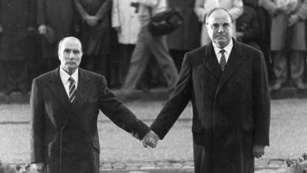 Late French President Francois Mitterrand and German Chancellor Helmut Kohl stand hand in hand