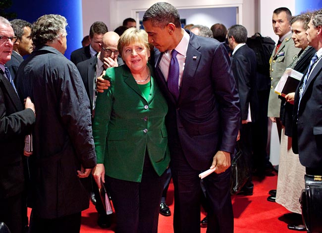 Making up: Barack Obama attempts to comfort Angela Merkel after a fractious meeting