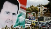 A photo taken on March 4, 2015 shows a banner bearing a portrait of Syrian President Bashar al-Assad in a street in the city of Damascus. AFP PHOTO / LOUAI BESHARA (Photo credit should read LOUAI BESHARA/AFP/Getty Images)