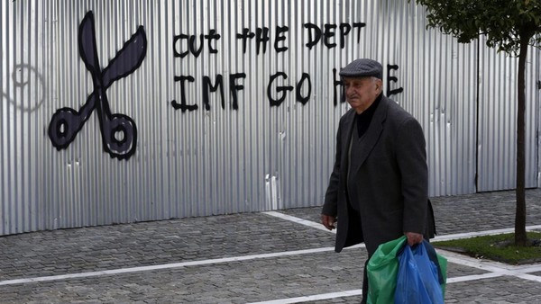 IMF Go Home" on corrugated metal fencing outside the University of Athens in Athens, Greece