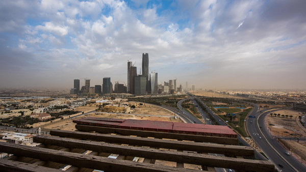 The King Abdullah financial district sits on the horizon seen from a skyscraper under construction in Riyadh, Saudi Arabia, on Sunday, Jan. 10, 2016. Saudi Arabian stocks led Gulf Arab markets lower after oil extended its slump from the lowest close since 2004. Photographer: Waseem Obaidi/Bloomberg