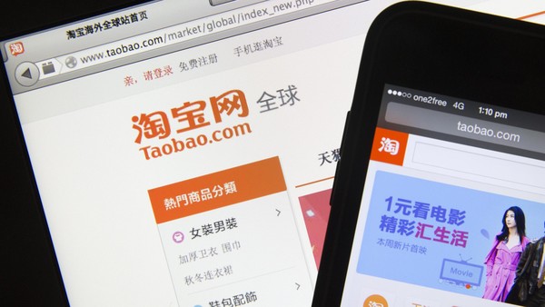 Taobao, a website of Alibaba Group Holding Ltd., is displayed on an Apple Inc. MacBook Air laptop, left, and iPhone 5c smartphone in an arranged photograph in Hong Kong, China, on Friday, March 21 2014. Alibaba, China’s biggest e-commerce company, said this month it will sell shares in the U.S. in what may be the largest-ever Chinese technology initial public offering. Photographer: Brent Lewin/Bloomberg