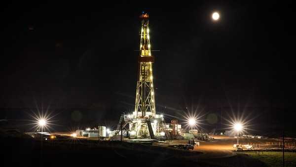 An oil derrick operated by Raven Drilling drills for oil in the Bakken shale formation
