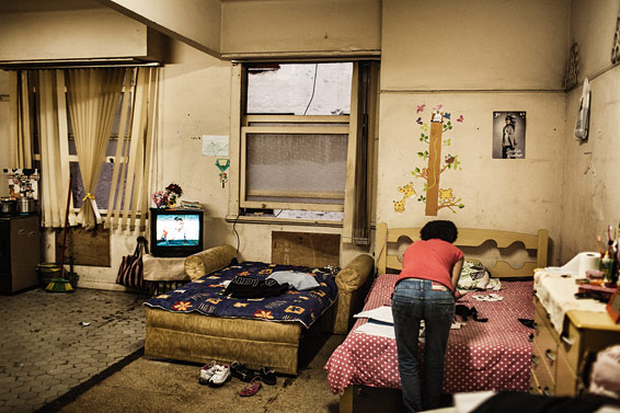A woman fixes things in one of the houses in Rio's many favelas