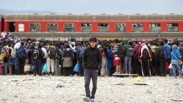 Migrants and refugees board a train after crossing the Macedonian-Greek border near Gevgelija on September 8, 2015. Tensions were running high at the border between Greece and Macedonia on September 7 with police stepping in to keep order amid the crowd of thousands massed at the frontier to journey to the European Union. More than 2,000 people entered Macedonia on September 7 while at least 8,000 waited on the Greek side to cross into the former Yugoslav republic, according to an AFP photographer on the spot.AFP PHOTO / ROBERT ATANASOVSKI