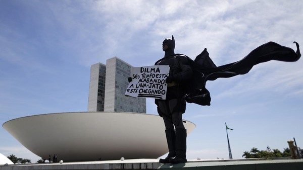 An anti-government demonstrator dressed as Batman stands in protest against corruption and against the induction of new members of the National Congress in Brasilia. February 1, 2015. Placard reads 