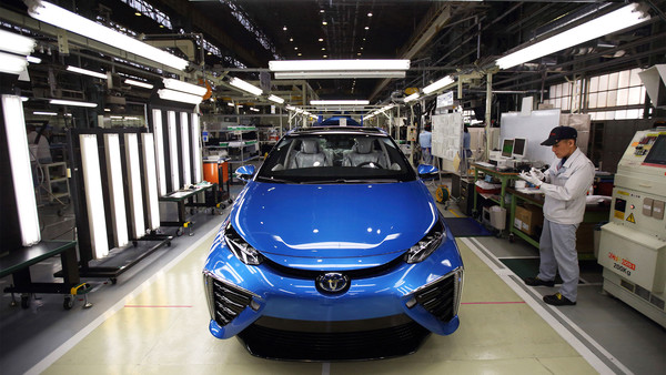 A Toyota worker checks a Mirai fuel-cell vehicle on the production line of the company's Motomachi plant