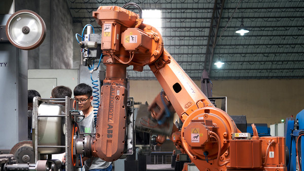 The technical staff repair the robot in YingAo Kitchen Utensils Co., Ltd.