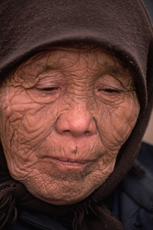 Close-up of the wrinkled face of a 99-year-old Evenki woman