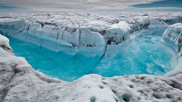 Meltwater rushes through a channel on the Greenland ice sheet
